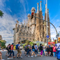 Tourists crossing the street to go to visit the Sagrada Familia basilica church