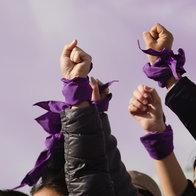 Purple bandanas wrapped around women's wrist representing fight for equal rights and protects against gender violence