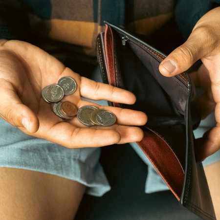 Man with wallet and little money