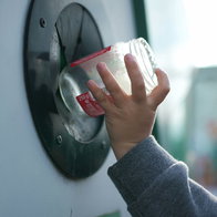 Boy recycling a glass jar