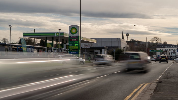Cars driving passed a petrol station