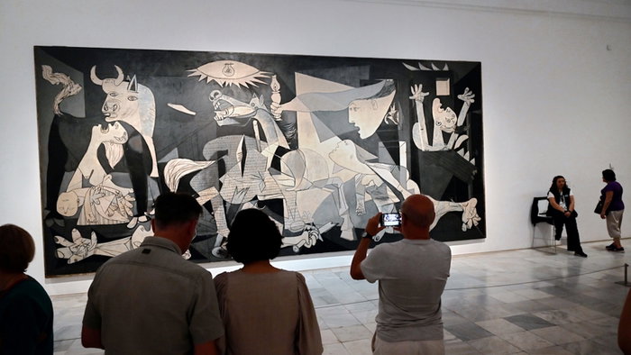 Visitors in front of Pablo Picasso painting Guernica