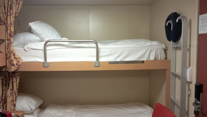 The curtain around each bunk is only real privacy you have in a place where you live, work, and sleep.