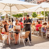 Busy restaurant terrace in Spain as bars face fines for unpaid overtime and long staff hours