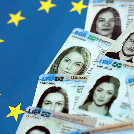 European residence permits displayed on an EU flag background