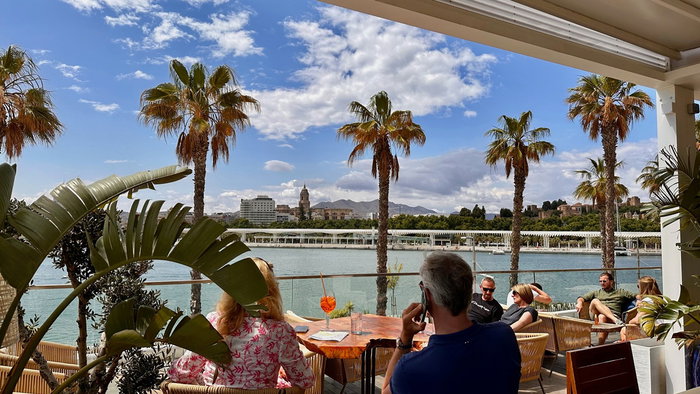 People sitting on a sunny restaurant terrace in Spain as new heatwave rules could affect outdoor service this summer