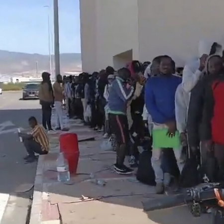 Massive queues in the elements in Roquetas del Mar, Almeria.
