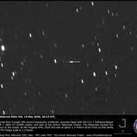 Telescope image showing near Earth asteroid 2026 JH2 approaching Earth, with an arrow marking the object against a star filled night sky.