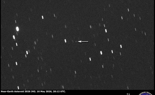 Telescope image showing near Earth asteroid 2026 JH2 approaching Earth, with an arrow marking the object against a star filled night sky.