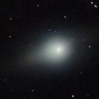 Comet 3I/ATLAS appears as a glowing object in deep space surrounded by distant stars.