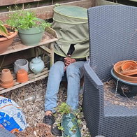 Man hiding under laundry basket