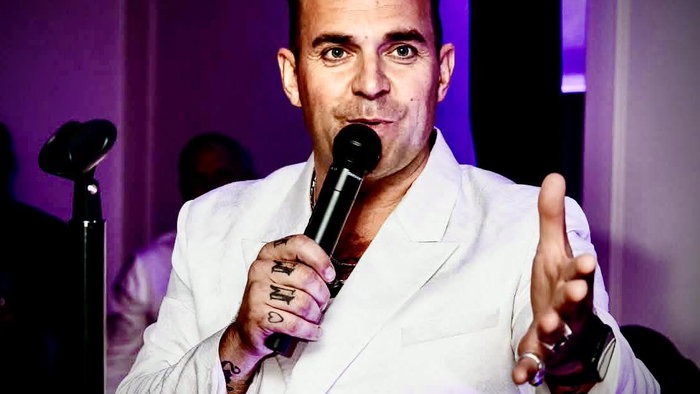 Tony Lewis as Robbie Williams.