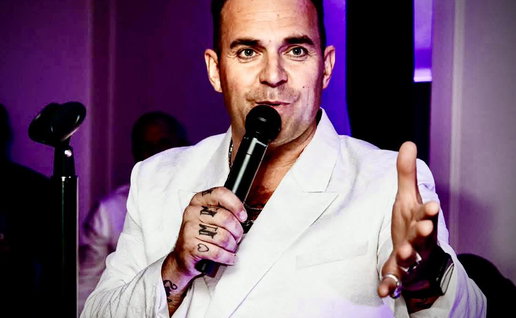 Tony Lewis as Robbie Williams.