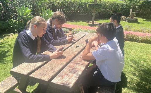 Students at the EIC engrossed in phones