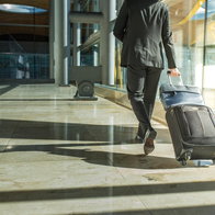 A traveller walking through an airport terminal with a suitcase, representing free movement and social security rights across the European Union.