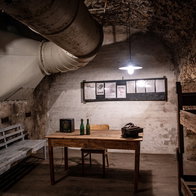 Interior of an underground bunker in Germany with wooden benches, bunk beds and ventilation pipes as Europe discusses civil defence preparedness.