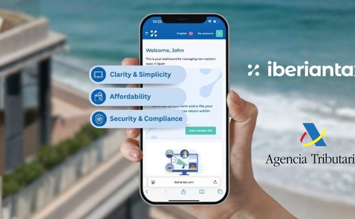Hand holding a mobile phone with details of Iberian Tax against a faded background of the sea