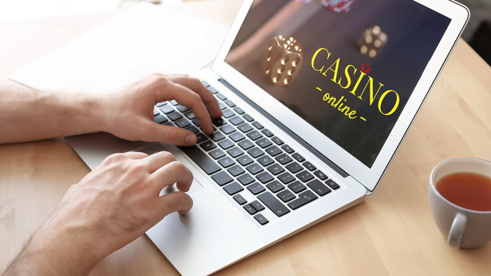 Man playing poker online on a laptop