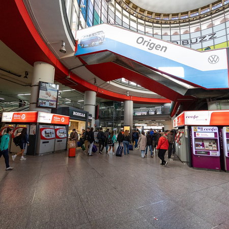 Passengers walking through a busy Renfe train station in Spain during the launch of discounted summer train tickets.