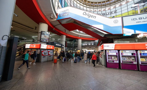 Passengers walking through a busy Renfe train station in Spain during the launch of discounted summer train tickets.