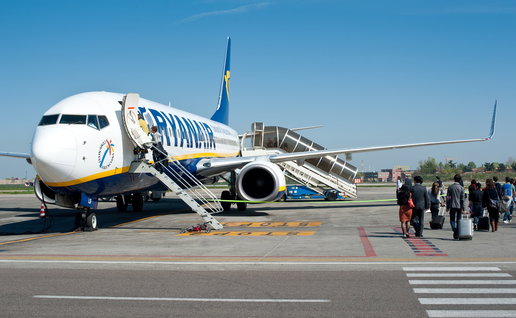 Passengers boarding a Ryanair aircraft on the airport runway before a flight from Spain to a European destination