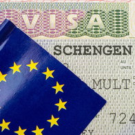 Schengen visa document and EU passport as travellers face growing visa appointment delays for summer 2026.