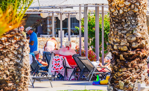 Tourist on sun loungers by a pool