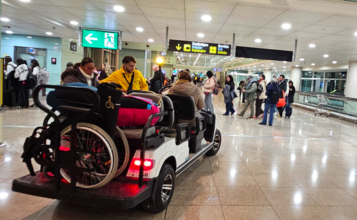 Mobility assistance buggy carrying two elderly passengers with a wheelchair