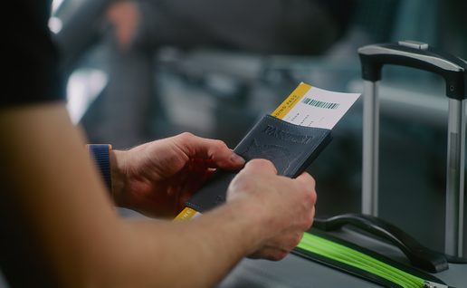 A man holding his passport and boarding pass