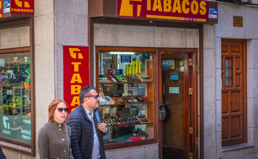 A couple walk past a tobacconists in Spain