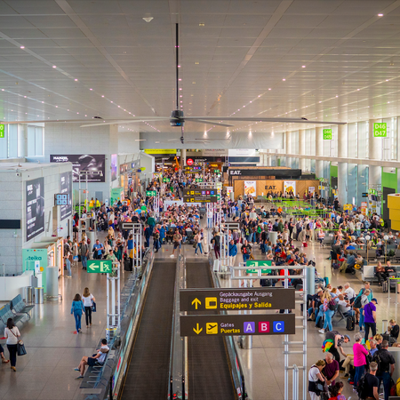 Passengers queueing to board there flights in Malaga airport