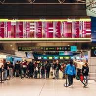 Passengers looking at their flight details in an airport