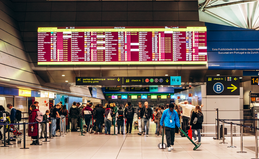 Passengers looking at their flight details in an airport