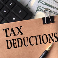 Tax deductions note with calculator and cash illustrating Spain home insurance tax benefit
