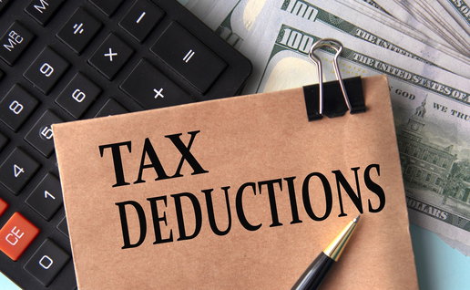 Tax deductions note with calculator and cash illustrating Spain home insurance tax benefit