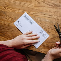 A driver opening an official traffic fine letter from Spain’s DGT after receiving a delayed driving penalty notice.