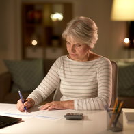 Retired woman reviewing financial paperwork at home as pensioners in Spain gain access to tax exemptions after turning 65.