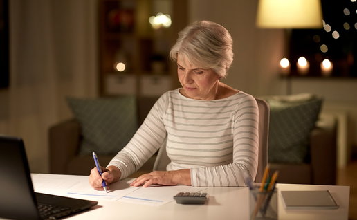 Retired woman reviewing financial paperwork at home as pensioners in Spain gain access to tax exemptions after turning 65.
