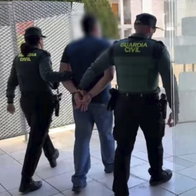 Matthew Joseph Smith being led away by Guardia Civil.