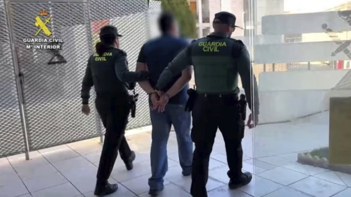 Matthew Joseph Smith being led away by Guardia Civil.
