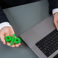 Man on laptop getting a loan at favourable rates