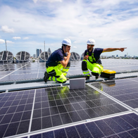 Workkmen fitting solar panels