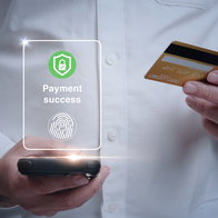 Person making a payment using biometric fingerprint authentication on a bank card