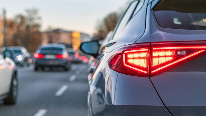 Car brake lights illuminated in traffic as new EU flashing brake light rule approaches