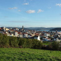 View of Cariño in Galicia, one of Spain's most affordable coastal towns, with houses overlooking the Atlantic coastline.