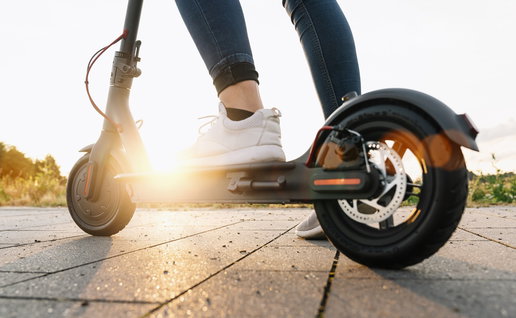 Close up of a person riding an electric scooter outdoors as Spain introduces new traffic restrictions for scooter users in certain urban areas.