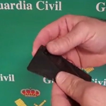 Guardia Civil officers demonstrate a concealed knife disguised as a wallet sized card during a social media warning video in Spain.