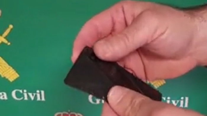 Guardia Civil officers demonstrate a concealed knife disguised as a wallet sized card during a social media warning video in Spain.