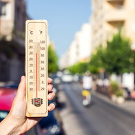 Thermometer showing extreme heat on a sunny street as Spain records its hottest April on record.