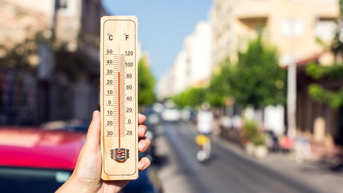 Thermometer showing extreme heat on a sunny street as Spain records its hottest April on record.